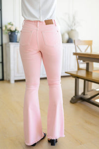 Feminine Flair Mid Rise Distressed Flares in Pastel Pink